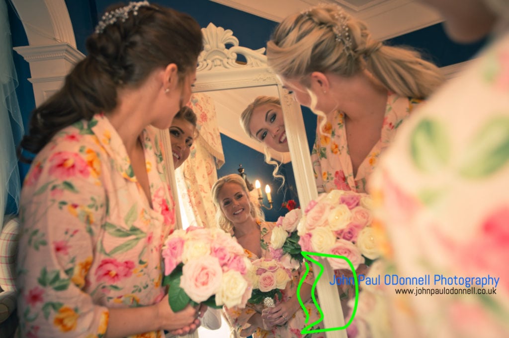 Bride and bridesmaids in the mirror in the bridal suite at mulberry house